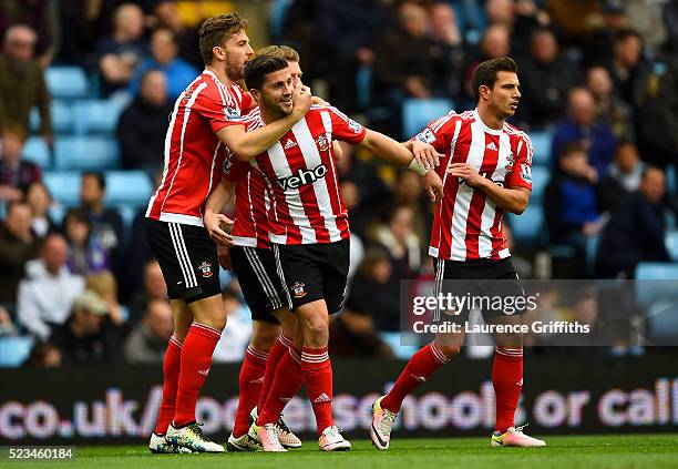 Shane Long of Southampton celebrates with Jay Rodriguez of Southampton and Cedric Soares of Southampton after scoring the opening goal during the...