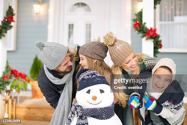family playing outdoors. - father and mother with their daughter playing in the snow stock pictures, royalty-free photos & images