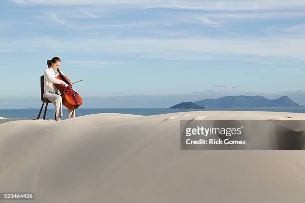 cellist playing outdoors - cello stock pictures, royalty-free photos & images