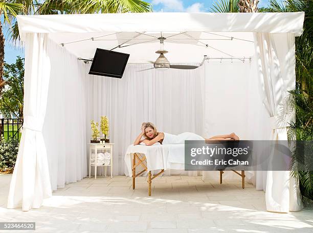 woman lying on massage table at spa - マッサージ台 ストックフォトと画像