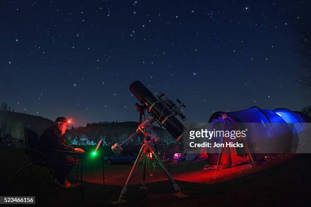 an amateur astronomer at a star party in herefordshire. - telescope stock pictures, royalty-free photos & images