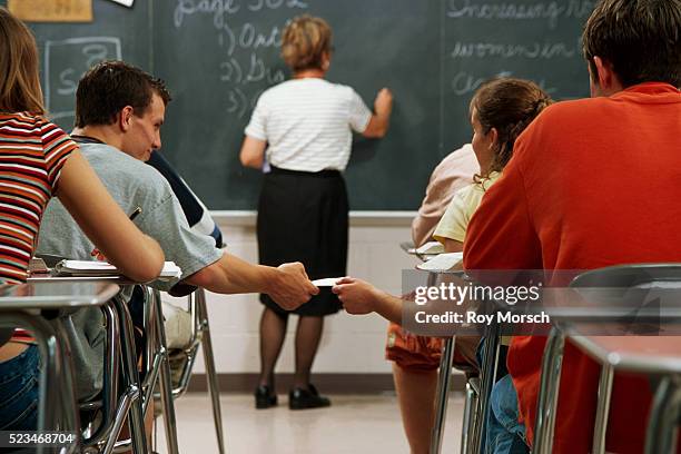 high school students passing notes - kids passing notes stock pictures, royalty-free photos & images