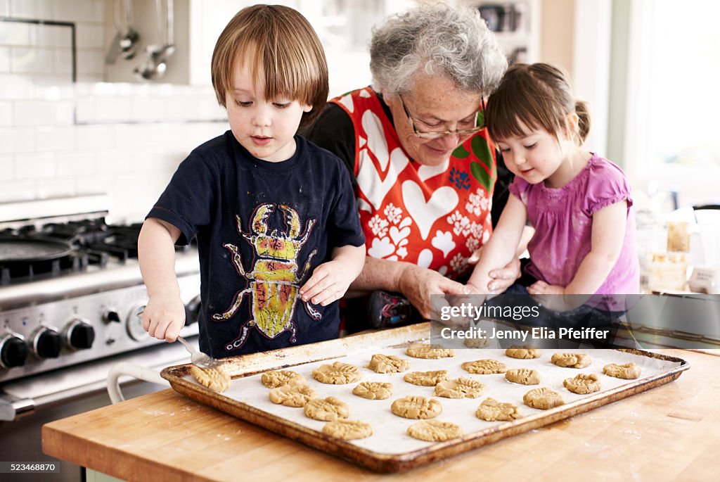 Grandma and grandchildren (3 yrs+2yrs) baking