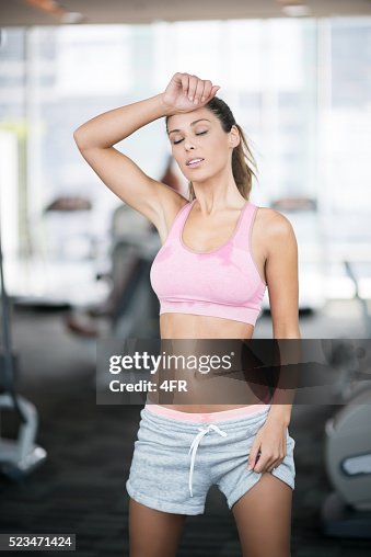 Sweating While Working Out Woman Sweating After Her Workout At The Gym High-Res Stock Photo ...