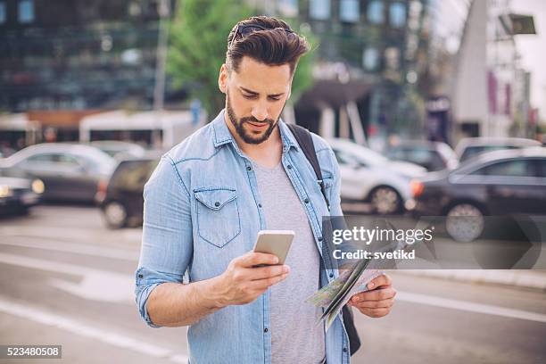 checking it twice - cell phone confused stockfoto's en -beelden