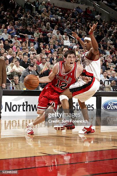 Kirk Hinrich of the Chicago Bulls takes the ball past Sebastian Telfair of the Portland Trail Blazers on March 9, 2005 at the Rose Garden Arena in...