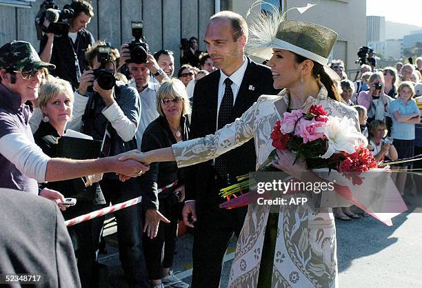 Crown Princess Mary of Denmark accompanied by her husband Crown Prince Frederik waves to wellwishers after a visit to the Tasmanian University Centre...