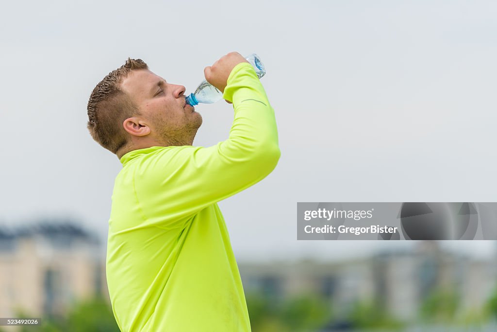 Man drinking water after workout