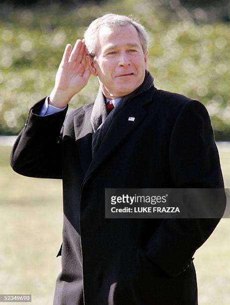 President George W. Bush jokes with reporters asking him questions as he walks to his helicopter on the South Lawn at The White House in Washington,...