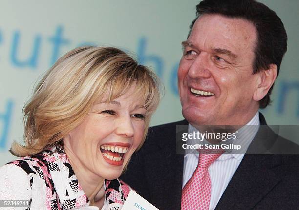 German Chancellor Gerhard Schroeder and his wife Doris Schroeder-Koepf share a laugh at the CeBIT technology trade fair March 10, 2005 in Hanover,...