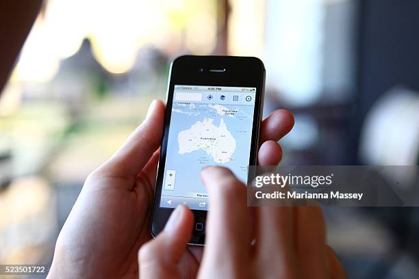 woman using her iphone - australia capital cities map stock pictures, royalty-free photos & images