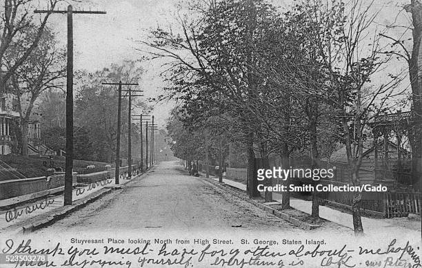 Postcard of a tree and homes lined road, with handwritten notes, titled "Stuyvesant Place looking North from High Street, St George, Staten Island",...