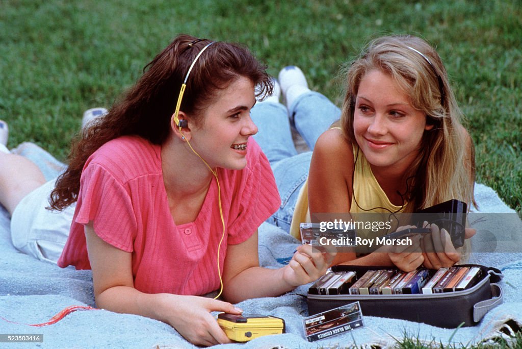 Two teenage girls listening to tapes