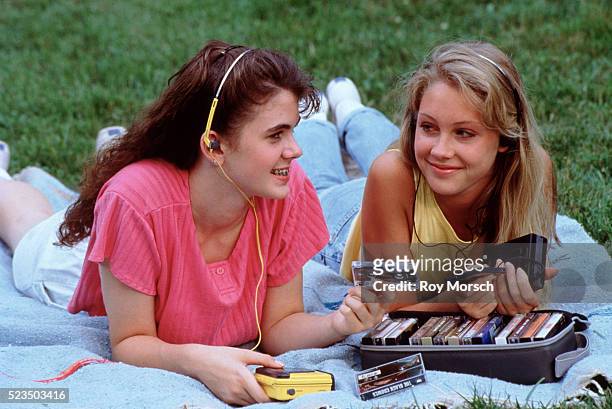 two teenage girls listening to tapes - cassette audio stock pictures, royalty-free photos & images