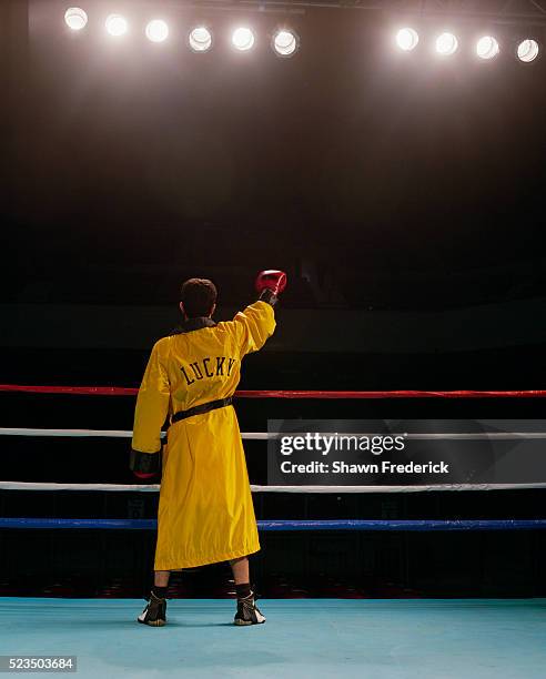 boxer raising arm in boxing ring - boxer vintage stockfoto's en -beelden