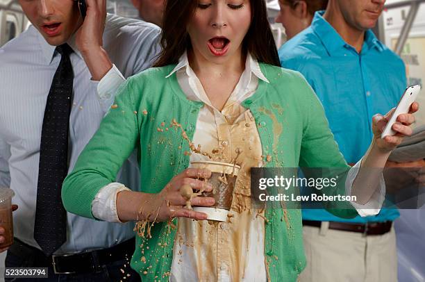 woman on busy subway spilling coffee - coffee splash stockfoto's en -beelden