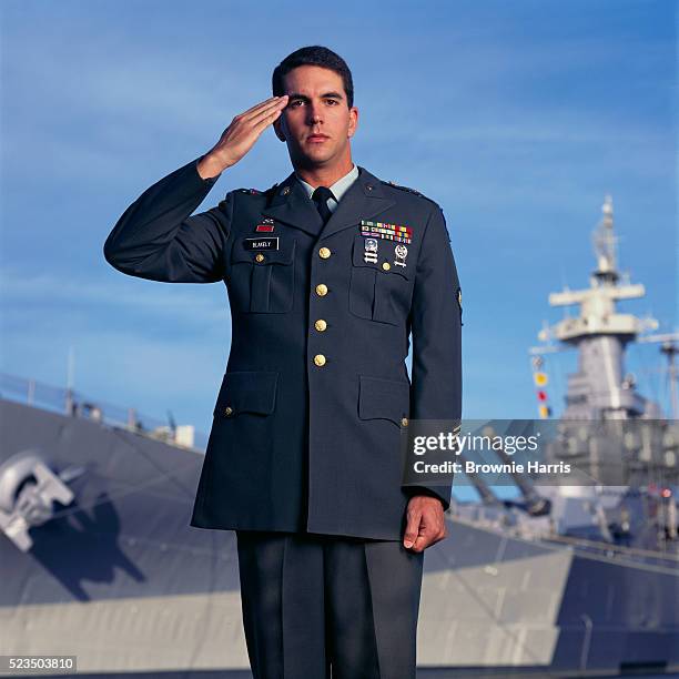 soldier saluting at the uss north carolina battleship - saluting stock-fotos und bilder