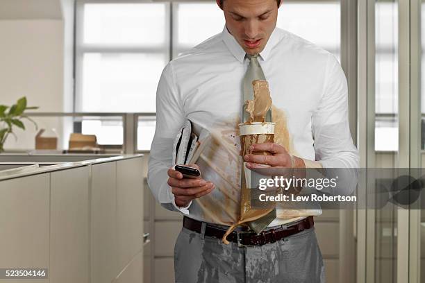 business man spilling coffee in office - spilled drink stock pictures, royalty-free photos & images