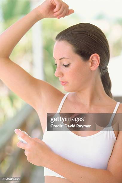 woman using deodorant - female armpits stock pictures, royalty-free photos & images