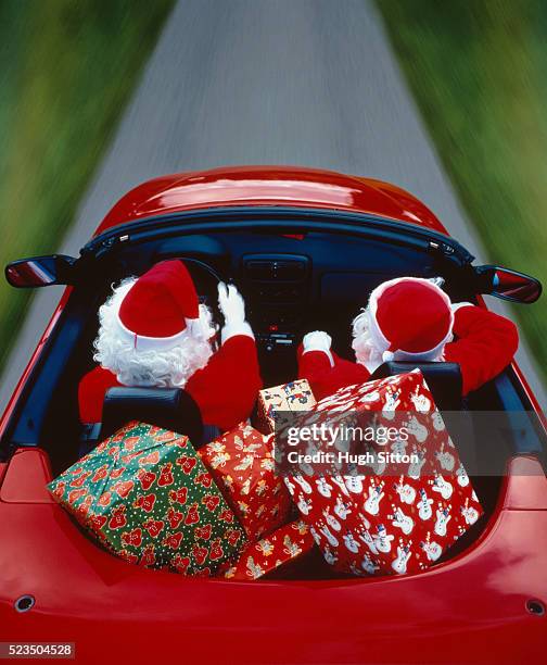 two father christmas driving a cabriolet - car wrapping foto e immagini stock