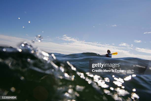 kayaker in choppy waters of stockholm archipelago - kayaking stockholm stock pictures, royalty-free photos & images
