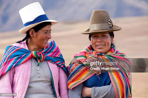two women in traditional costume walking in the mountains, near moray. peru. - cordigliera delle ande foto e immagini stock