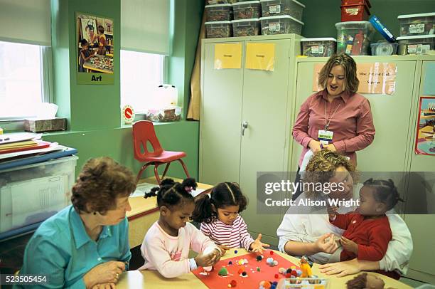 children and care givers at a child crisis nursery - child poverty stock pictures, royalty-free photos & images