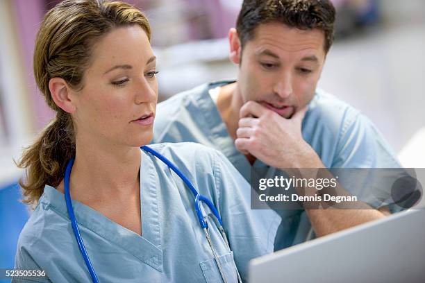 nurses using laptop - nurse thinking stock pictures, royalty-free photos & images