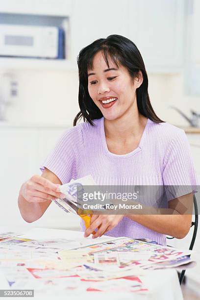 woman clipping coupons - coupons stock pictures, royalty-free photos & images