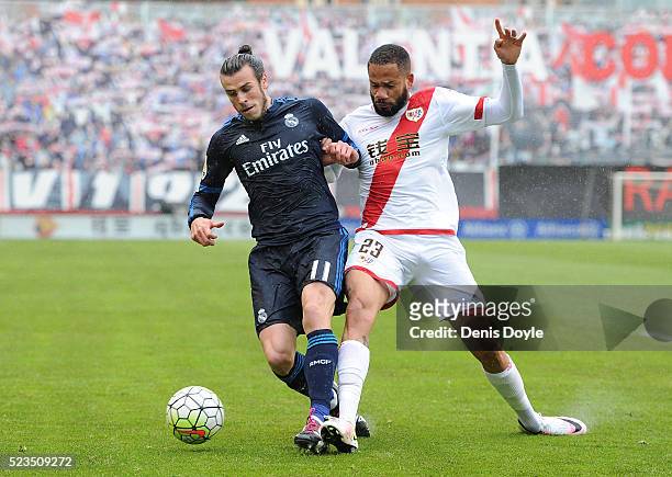 Gareth Bale of Real Madrid is tackled by Tiago Manuel Dias Correia 'Bebe' of Rayo Vallecano de Madrid during the La Liga match between Rayo Vallecano...