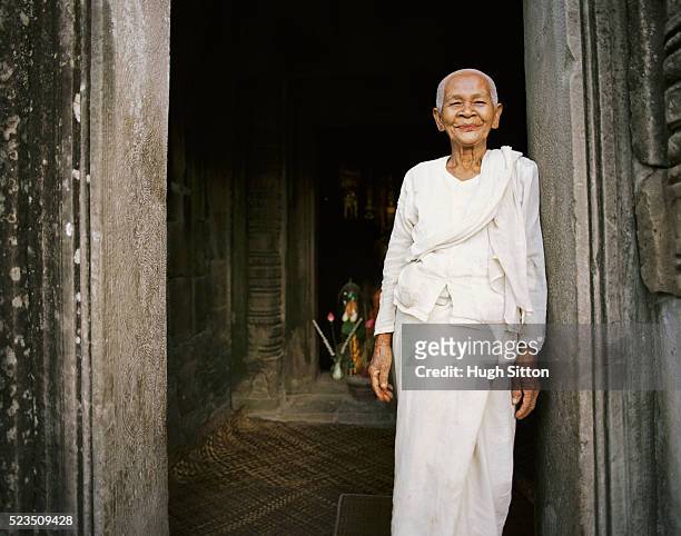senior woman in white clothes at temple - cambodian ethnicity stock pictures, royalty-free photos & images