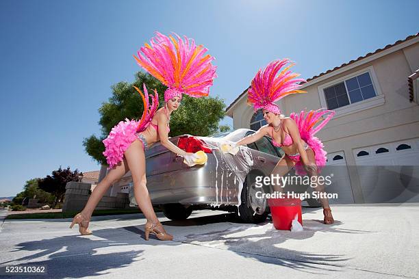 showgirls washing car outside house - pink feathers stock pictures, royalty-free photos & images