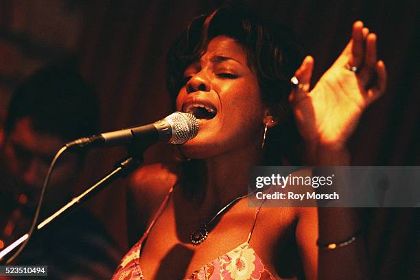 woman singing into microphone - blues music stock pictures, royalty-free photos & images