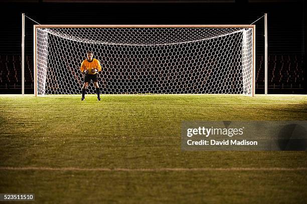 soccer goalie anticipating ball - doelman stockfoto's en -beelden