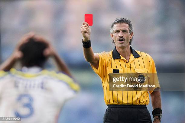 soccer referee handing out a red card - bestrafung stock-fotos und bilder