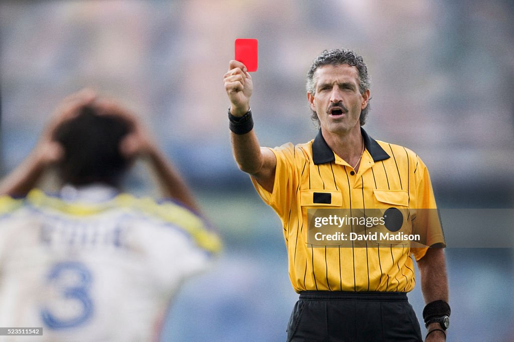Soccer Referee Handing Out a Red Card