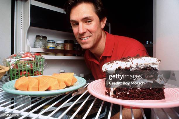 man deciding on snack - funny fridge foto e immagini stock