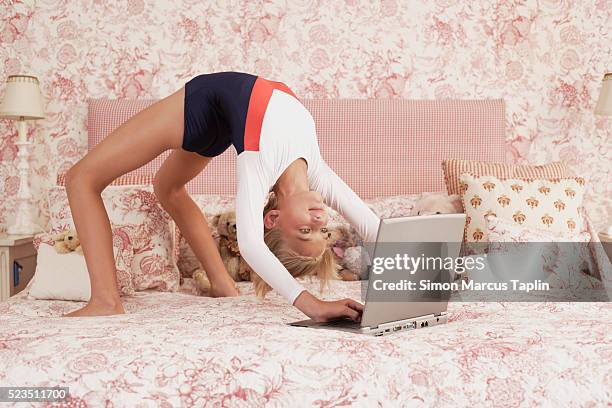 girl doing backbend while using laptop - head back stock pictures, royalty-free photos & images