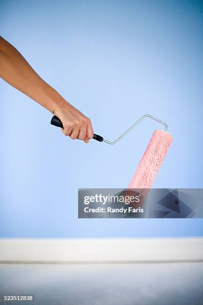 woman painting walls of room - holding paint roller stock pictures, royalty-free photos & images