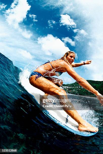 surfer riding a wave - woman surfing stock pictures, royalty-free photos & images