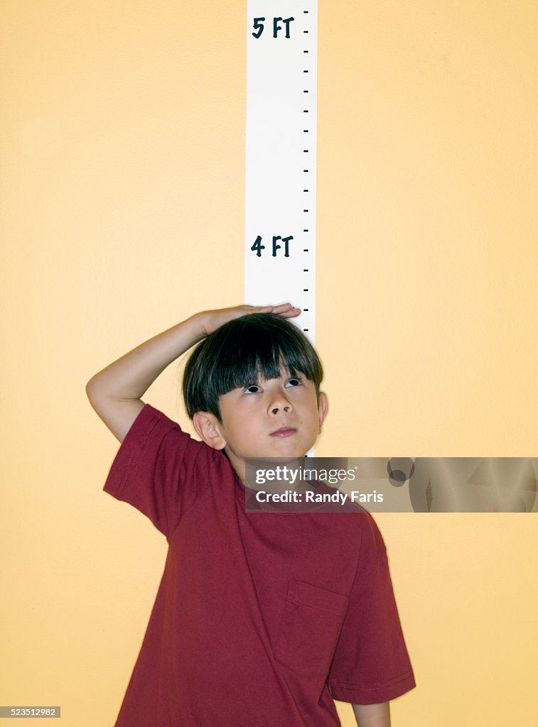 Boy Measuring His Height