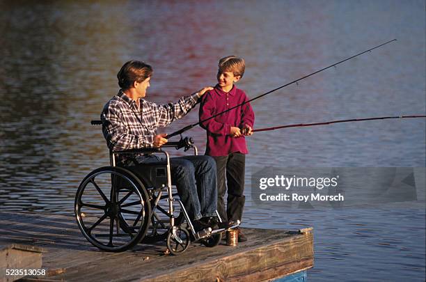 nine-year-old and physically challenged father fishing - vintage fishing lure stock pictures, royalty-free photos & images