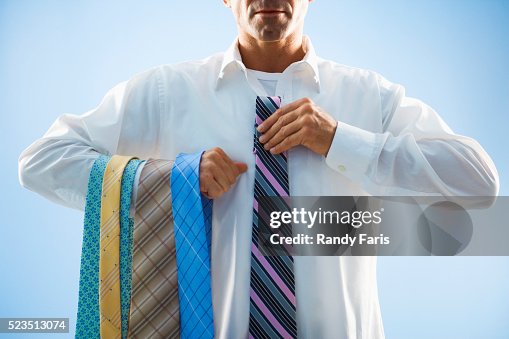 Businessman Selecting Tie Businessman Selecting Tie
