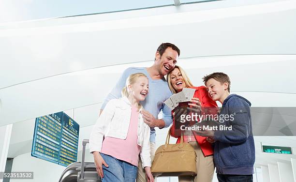 family with two kids (7-9,10-12) at airport going on holiday - plane ticket stock pictures, royalty-free photos & images