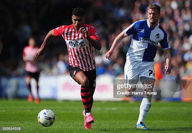 Ollie Watkins of Exeter City is tackled by Lee Mansell of Bristol Rovers during the Sky Bet League Two match between Bristol Rovers and Exeter City...