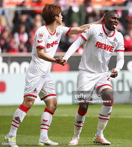 Anthony Modeste of Cologne is helped up by Yuya Osako during the Bundesliga match between 1. FC Koeln and SV Darmstadt 98 at RheinEnergieStadion on...