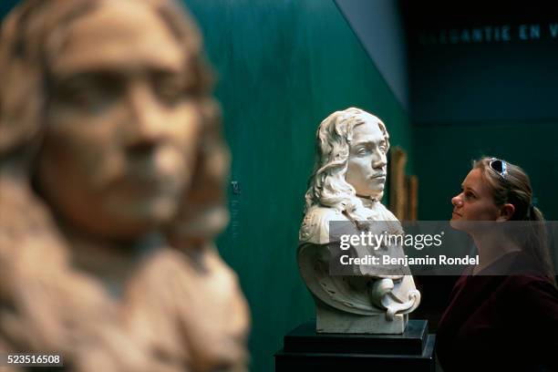 woman looking at bust statue - beyond museum stock pictures, royalty-free photos & images