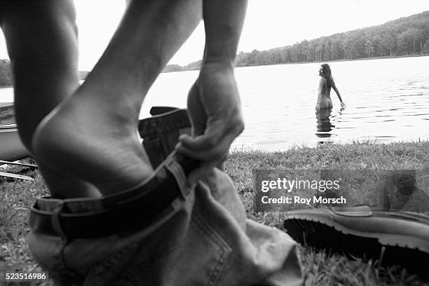 couple going skinny dipping - skinny dipping stock-fotos und bilder