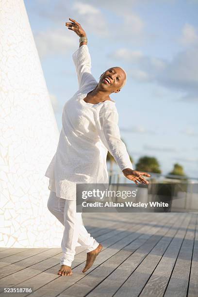 senior woman dancing on a deck - active seniors dancing stock pictures, royalty-free photos & images