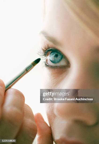 girl applying makeup - kajalschminke stock-fotos und bilder